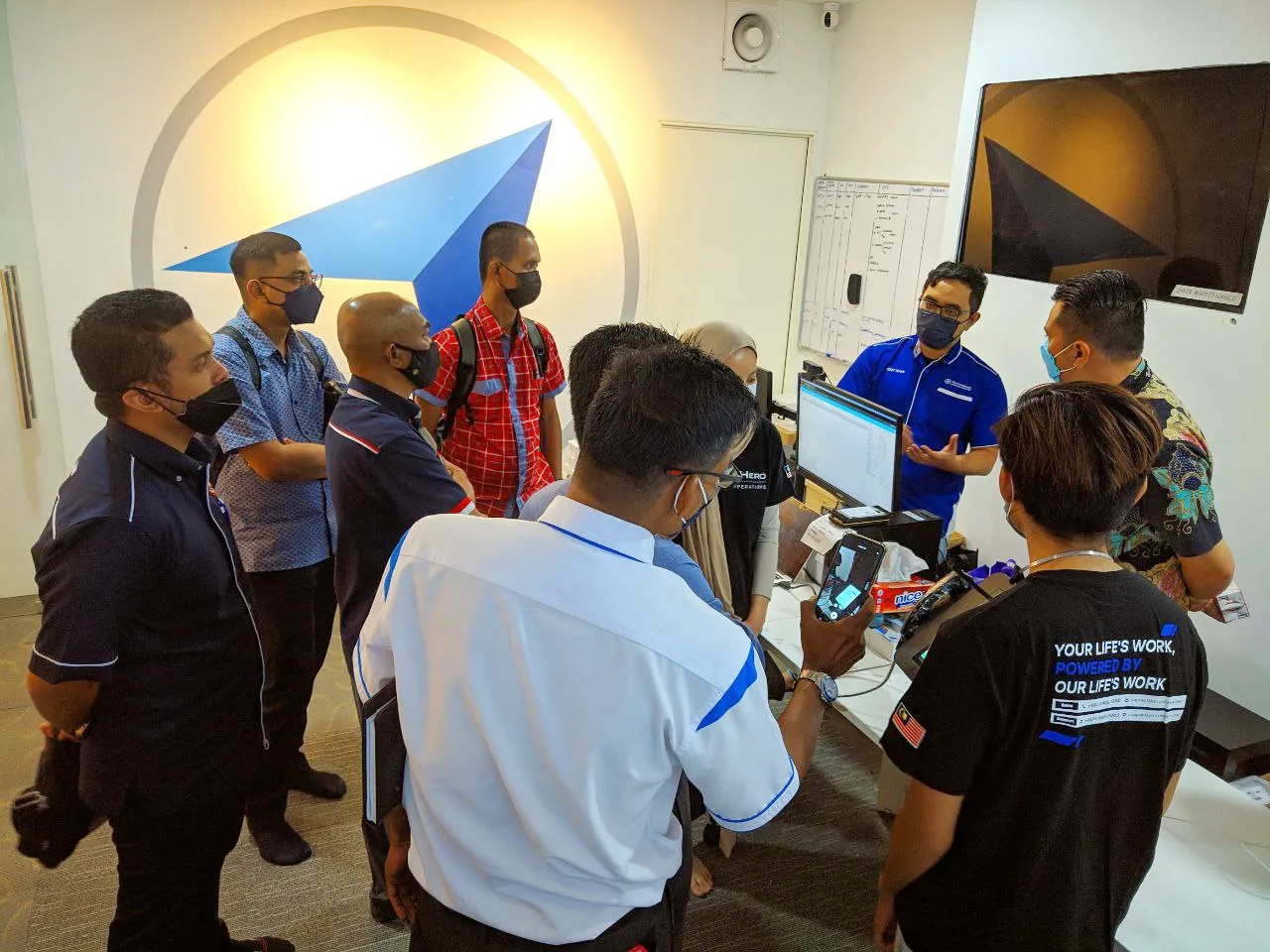 TrackerHero staff showing the patrol system to visitors in the headquarters control room